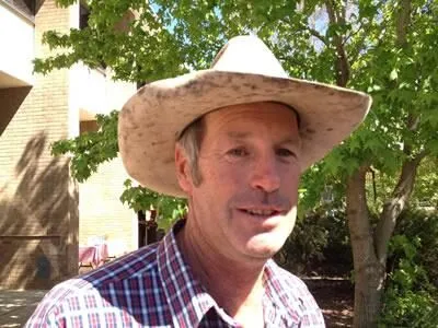 A grower in a weathered Akubra at his stall